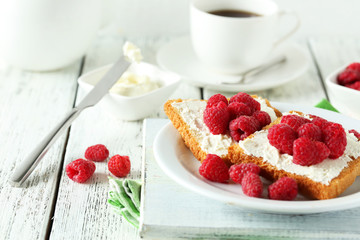 Fresh toast with raspberry on white wooden background