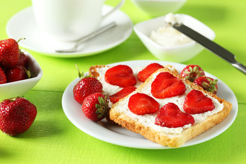 Fresh toast with strawberry on green wooden background