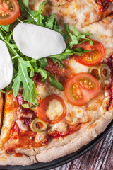 Vegetarian pizza with mozzarella and arugula.
