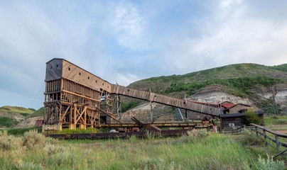 Fototapeta premium An old and historic coal mine building in the badlands region near Drumheller Alberta Canada at sunset.