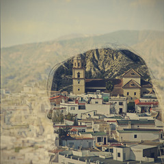Double exposure of woman and town