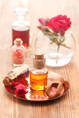 Obraz na płótnie Canvas Rose essential oil, sea salt and flowers roses. Spa, body care, aromatherapy.