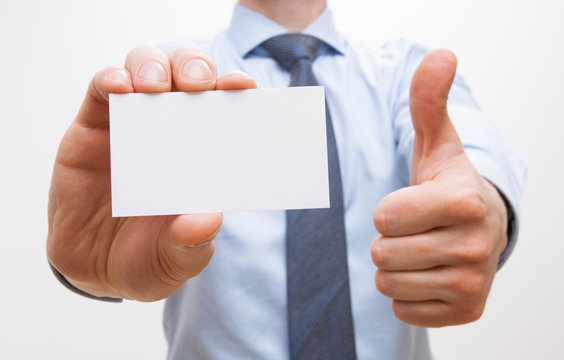 Unrecognizable businessman showing  visiting and thumb up sign