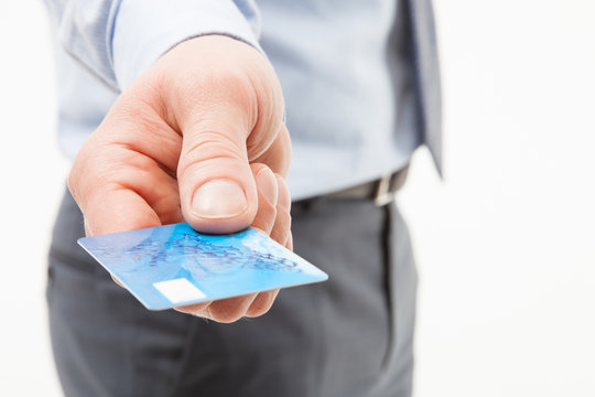 Businessman's hand giving credit card