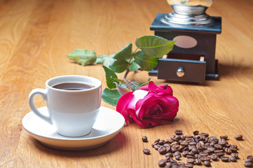 Vintage coffee mill, cup and rose