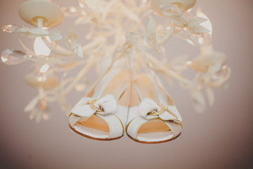 Closeup of bridal elegant white wedding shoes