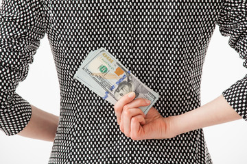 Unrecognizable businesswoman hiding money behind back