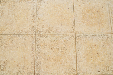 Old floor small tiles beige stone pavement