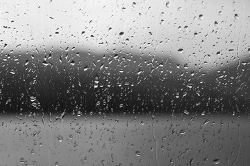 Rain drops on a window or water drops on grass background