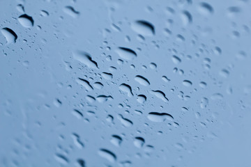 Rain drops on a window or water drops on grass