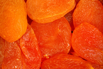 Dried apricot fruit forming a background.