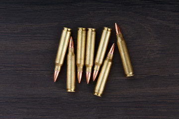 Old ammunition on the wood background. Army equipment.
