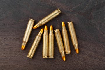 Cartridges on old wooden table.
