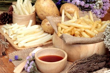 French fries and fresh sliced potatoes with ketchup.