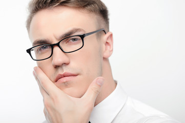 Close-up of man in glasses touching his face