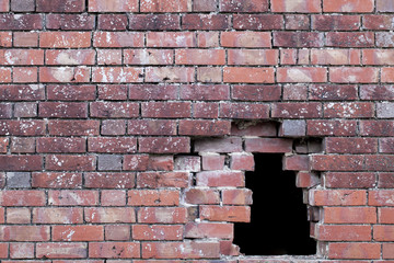 Hole in an old brick wall
