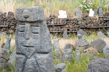 Grey lava stone sculpture of an old king