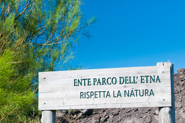 Wooden sign with the indication of Mount etna park along the trails of the volcano