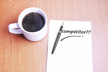 Coffee, pen and notes write competitor