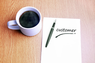 Coffee, pen and notes write customer