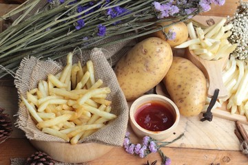 French fries and fresh sliced potatoes with ketchup.