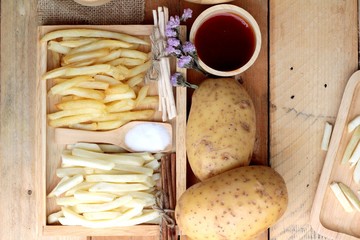 French fries and fresh sliced potatoes with ketchup.