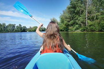 Kayaking. The woman floating on the river kayak