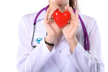Young woman doctor holding a red heart, isolated on white