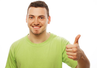 young man in green shirt  showing thumbs up. 