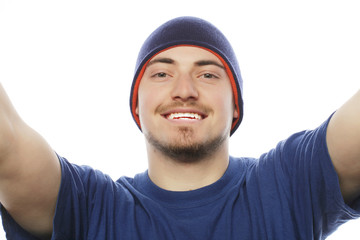 young man holding camera and making selfie 