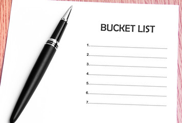 Pen  and notes paper with bucket list