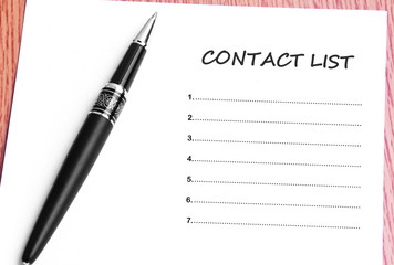 Pen  and notes paper with contact list