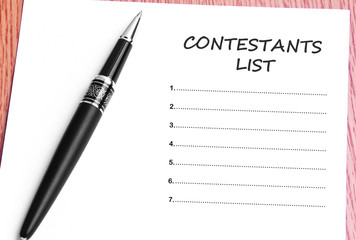 Pen  and notes paper with contestants list
