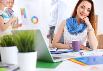 Portrait of attractive female  designer in office