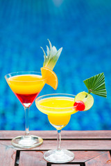 colorful cocktail with orange by the pool