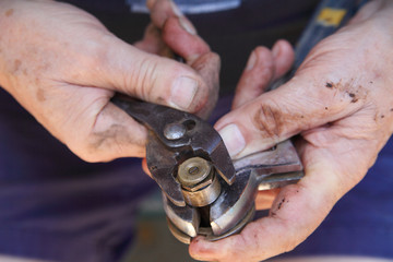 Man tightens sprinkler head with pliers