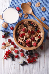 Fototapeta na wymiar muesli with fresh berries and milk on the table. vertical top view 