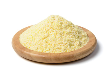 uncooked yellow corn flour in the wooden plate, tilt shift lens