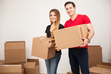 Cute couple carrying boxes