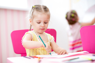 kids girls painting in nursery at home