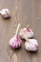Garlic bulbs on wooden table, selective focus