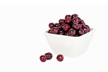 Ripe cherries in a white bowl