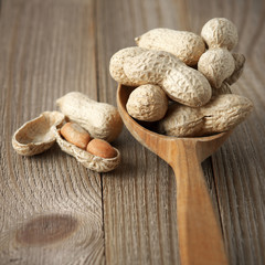 Peanuts in wooden spoon