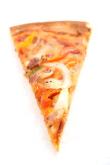 One single piece of pizza with tomato