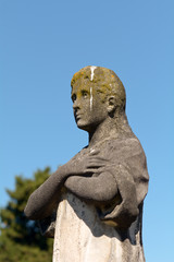 Fototapeta na wymiar Grave stone statue of man covered in bird poo in Bordeaux, France