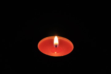 red candle with black background
