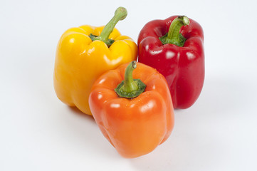three fresh paprikas on white background	