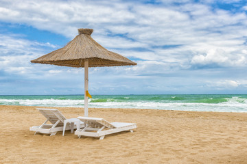Black Sea beach with umbrellas, fine sand, cool water and blue sky