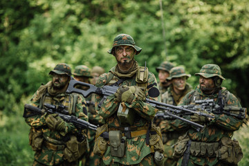 Fototapeta premium Group of soldiers special forces during the raid in the forest