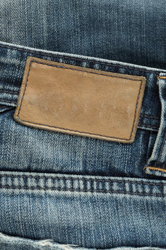 brown leather tag label on blue jeans